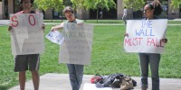 Three students protested outside a talk by Dougla Oberhelman, Caterpillar CEO, Thursday. (MEHMET INONU/The Stanford Daily)