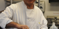 Chef Frank Hassan, shown here cooking in his beloved Bollard Eating Club, is set to lose his job at the end of this academic year. (MEHMET INONU/The Stanford Daily)